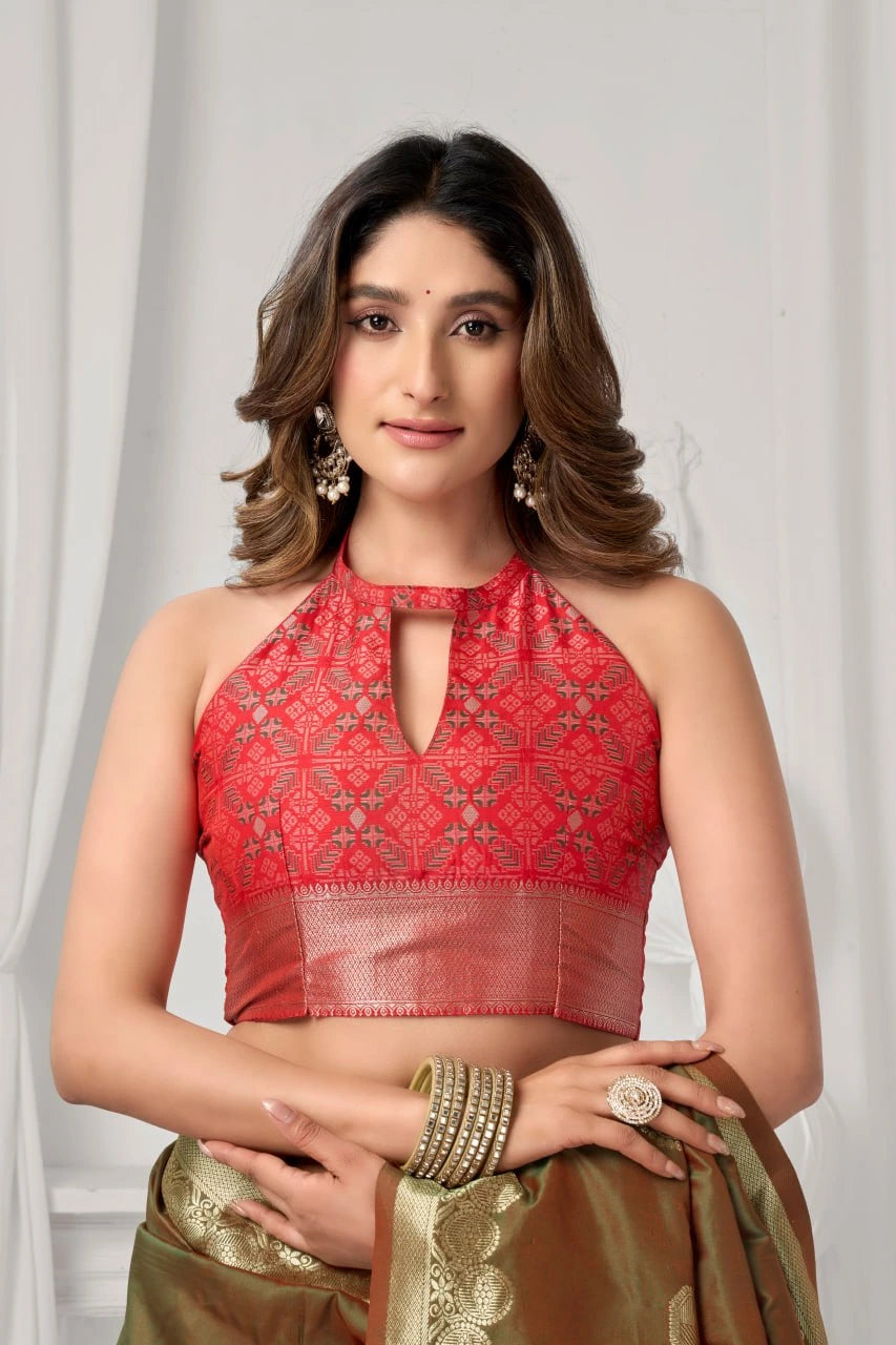 Woman wearing a red embroidered top with a plain background